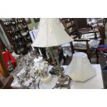 A pair of gilt table lamps, together with two further lamps & a candle stick