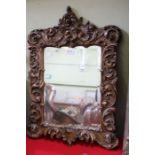 A gilt fancy scrolled mirror