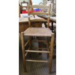 A child's ladder back tall rush seated chair.