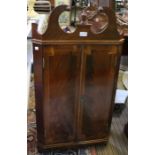 A reproduction Georgian design mahogany hanging corner cupboard, with key