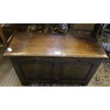 A small sized reproduction oak plain paneled coffer.