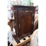 An 18th century oak corner cupboard