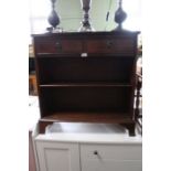 Reproduction mahogany low bookcase with two inline drawers.