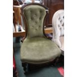 A late Victorian nursing chair, green upholstered with button back.