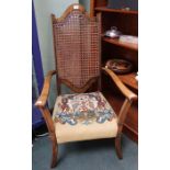A bergere armchair with heraldic seatpad