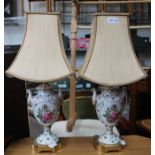 A pair of pottery table lamps with shades.