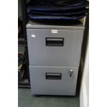 A metal two drawer filing cabinet with key