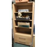 A modern three shelf bookcase with two draws below.