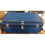 A blue cabin trunk with brassed fittings.