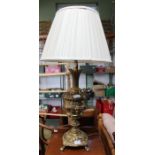 A decorative brass lamp with shade.