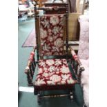 An American turn wood frame rocking chair with upholstered seat and back.