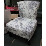 A contemporary floral fabric upholstered chair.