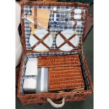 A vintage wicker picnic set with complete contents.