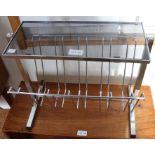 A 1970's chromed magazine rack with smoked glass tabletop