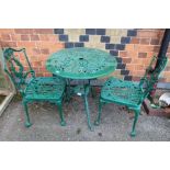 A green painted cast metal table and chairs set, three piece.
