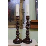 A pair of carved & twisted candle sticks retailed by Mulberry, 46cm high