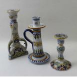 Three various faience candlesticks, decoratively painted, tallest 25cm