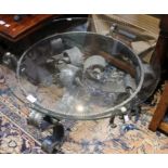 A pair of wrought metal and glass top coffee tables