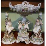 A German porcelain centrepiece basket on putti stem, c.1900, 43cm high, together with a pair of figu