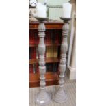 A pair of modern wooden floor standing candle-sticks, 97.5cm high