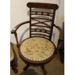 An Edwardian inlaid mahogany swivel arm chair with woodland creature decorated pad seat, 81cm high