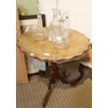A fancy walnut topped table with tilting action, on carved column & three scrolling legs, 65cm high