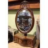 A Continental design adjustable dressing table mirror with oval plate