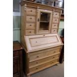 A multi drawer top with central cupboard over fall down front and three full width drawers, 173cm x