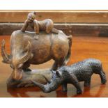 A Japanese carved wood 'Boy on Ox' and a carved African Rhino