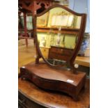 A dressing table mirror mounted on a three draw platform.