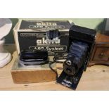 A boxed unused Akita APR 35mm camera, 2A folding Brownie camera and a boxed Lucas portable iron of a
