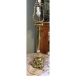 A brass table lamp, with decorative base