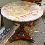 A marble topped table with turned column & scrolling metal supports, with applied cast metal claw fe