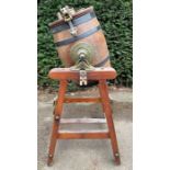 A vintage banded oak barrel from butter churn on pine stand, brass mounts stamped “Dairy Outfit Co.L