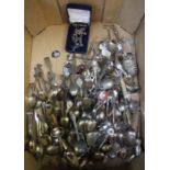 A large collection of spoons etc to include silver items and a jewellery trio.