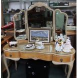 A modern glass topped fancy dressing table with three plate mirror.