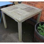 A square outdoor garden dining table