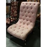 An Edwardian nursing chair, turned fore supports, button pink upholstery.