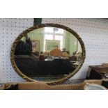 A small gilt framed oval mirror