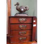 An Edwardian cabinet of four small drawers, 30cm wide, together with a cast metal Dodo door stop