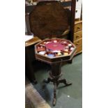 A 19th century walnut needlework table, fitted interior with contents, with under storage, raised on