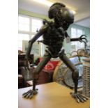 An 'Alien' creature statue assembled using reclaimed motor / manufacturing parts, having movable tor