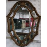 A fancy gilt framed shield shaped mirror