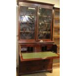 A 19th century mahogany Secretaire - having lattice bar glazed bookcase top over a four drawer base