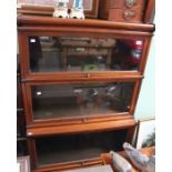 A mahogany Globe Wernicke bookcase, with brake front lower section, three tiers all with glazed door