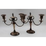 A pair of Old Sheffield plate table candelabra, Adam twin branch design, with extinguisher's, on ova