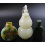 Three Archaic design Chinese snuff bottles, carved from various green stones, including mutton fat t