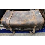 A large leather twin handled travelling trunk, with two straps & lock
