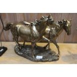 Bronze effect cast resin model of two playful horses, 30.5cm high