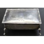 An early 20th century rectangular silver jewellery box, the hinged cover engraved with floral swags